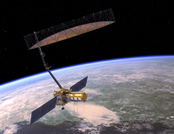 An artist's concept of NISAR orbiting Earth. The satellite's mesh antenna and reflector are visible overhead, at the end of t